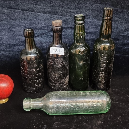 131 - Five wonderful antique and vintage Irish glass drinks bottles including a G.H. Left Enniscorthy roun... 