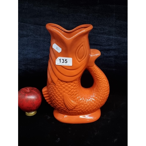 135 - A bright ceramic fish gluggle jug with the tail forming the handle. A real statement piece.