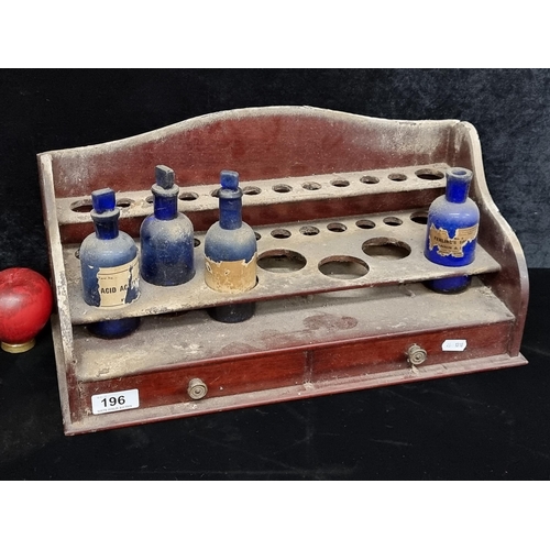 196 - An antique Irish apothecary wooden stand with original pharmacy cobalt blue glass bottles and an arr... 