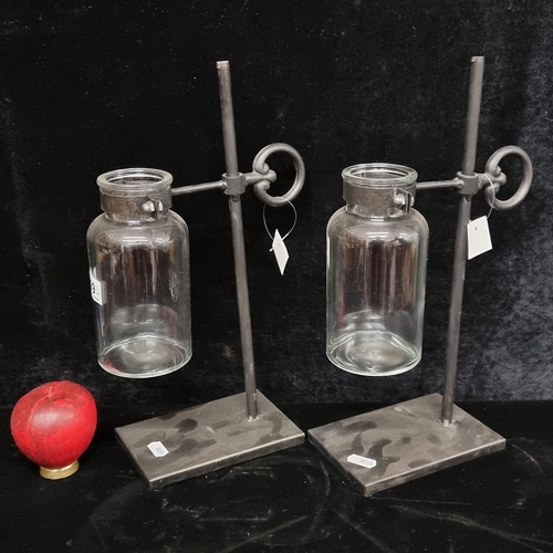 199 - A pair of glass bottle vases with metal stands. A tea light would look great in these.