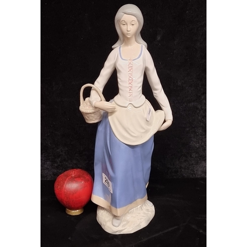 200 - A tall porcelain figure of a lady strolling with basket in hand by Rex Valencia, hand painted in sof... 