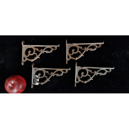 216 - A set of four cast metal wall brackets featuring scroll like design.