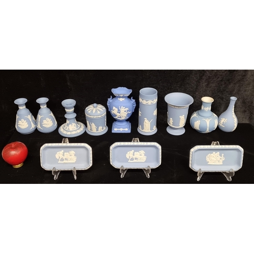 232 - A collection of 12 Wedgwood Jasperware pieces including bud vases, candlesticks, and three plates wi... 