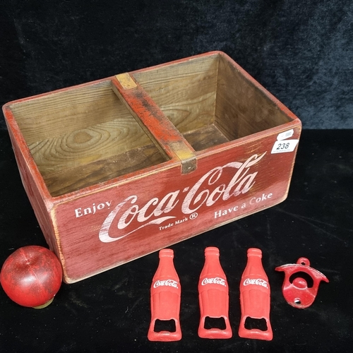 238 - A vintage style Coca Cola wooden crate containing four Coca Cola bottle openers.