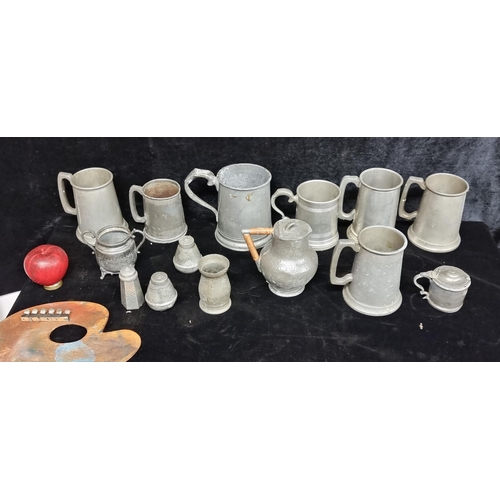 239 - A box containing a selection of antique pewter tankards and jugs including a hammered example. Lot a... 