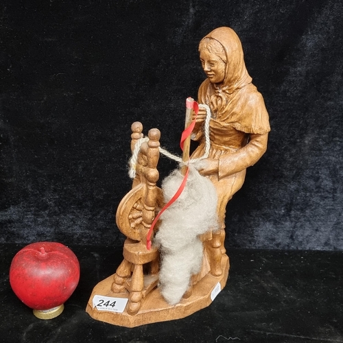 244 - A nicely detailed hand carved wooden figurine of old women with spinning wheel.