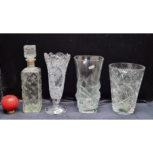 283 - Four pieces of cut glass including a decanter with original stopper and an elegant vase with floral ... 