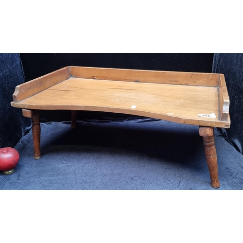 290 - A delightful vintage wooden breakfast tray table featuring fold-away legs for easy storage.