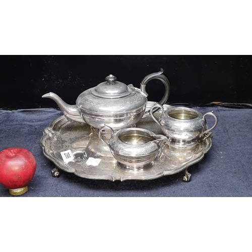 296 - A four piece silver plate tea service incluidng a teapot, creamer, sugar bowl and footed serving tra... 