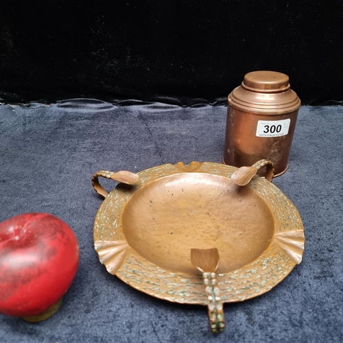 300 - A heavy quality Art Nouveau hammered copper ash tray with a copper tobacco jar.