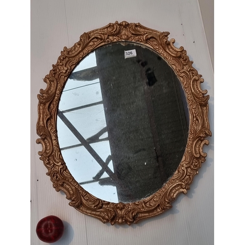 326 - A Baroque style oval wall mirror.