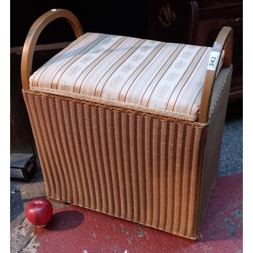 343 - A fabulous Llyod Loom padded dressing table stool with gilt wicker design and hinged lid.