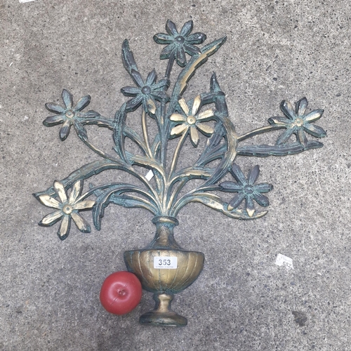 353 - A decorative cast metal wall hanging in the form of daisy flowers in urn.