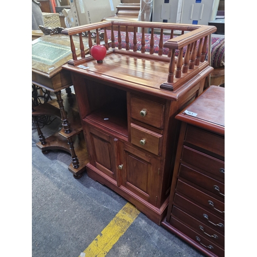 360 - A lovely solid wood cabinet with turned wood gallery back with brass hardware. Handsome piece.