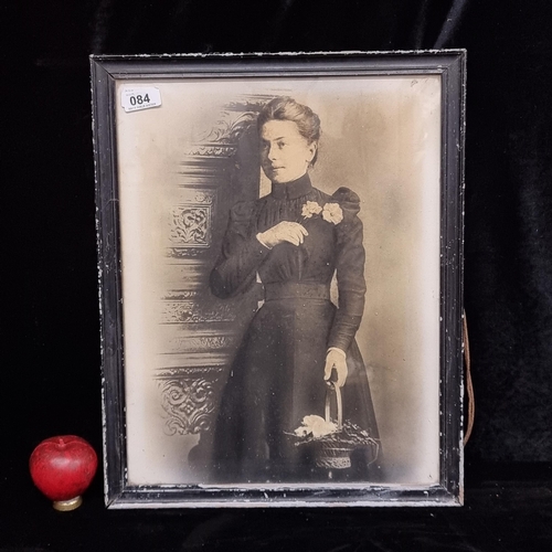 84 - A print of a elegant Victorian Lady. Housed in a black frame behind glass.