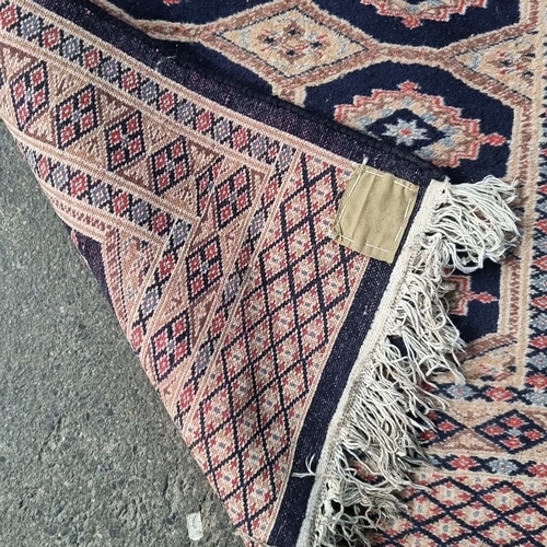 430 - Star Lot : A long Handwoven Persian-style wool runner, featuring geometric motifs in rich navy and b... 