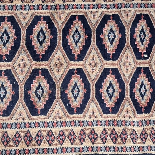 430 - Star Lot : A long Handwoven Persian-style wool runner, featuring geometric motifs in rich navy and b... 