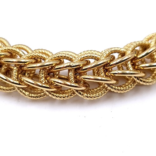 8 - Super Star Lot:
An 18ct gold bracelet with a delicate intertwined band and a heavy gold clasp.

Leng... 