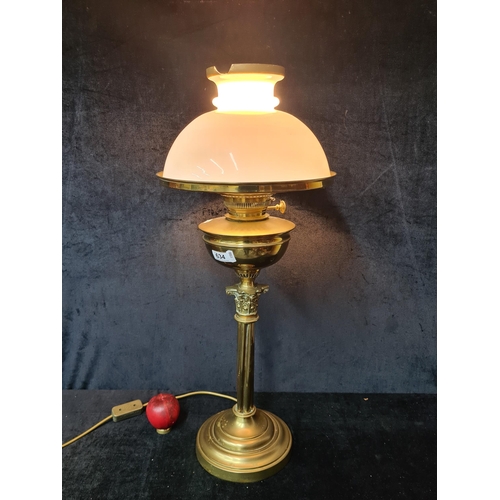 A magnificent tall Victorian Hinks & Son brass oil lamp with white glass shade supported above the reservoir on a decorative Corinthian column base. Chipped to very top of class but still a very beautiful piece, has been converted into an electric lamp with three pin plug.