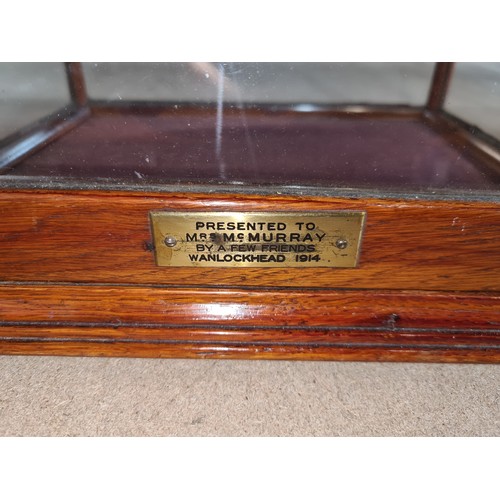 390 - A handsome Edwardian oak glass fronted display case with mounted brass name plaque to front. We have... 