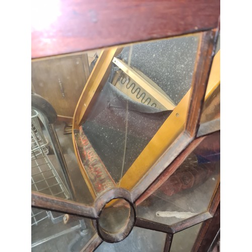 408 - Early 20th-century mahogany display cabinet, featuring glazed doors with geometric detailing, red fa... 