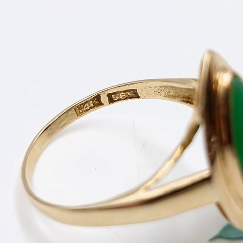 574 - A nine carat gold jade ring. Size - M. Weight - 2.21 grams. Boxed.