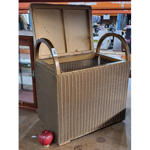 343 - A fabulous Llyod Loom padded dressing table stool with gilt wicker design and hinged lid.