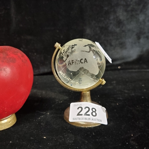 228 - A heavy small glass desk globe.