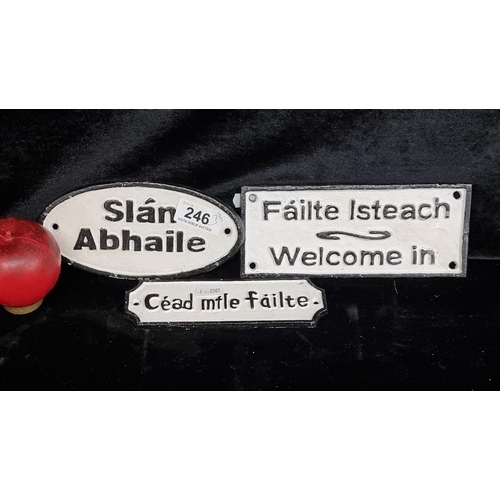 246 - Three black and white cast metal wall plaques reading in As Gaeilge.