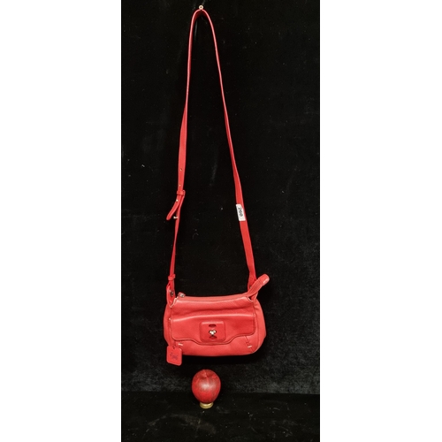 260 - A fashionable Radley bright red leather hand bag. With the iconic Scottie dog tag.