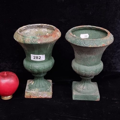 282 - A pair of neat size heavy cast iron urns.