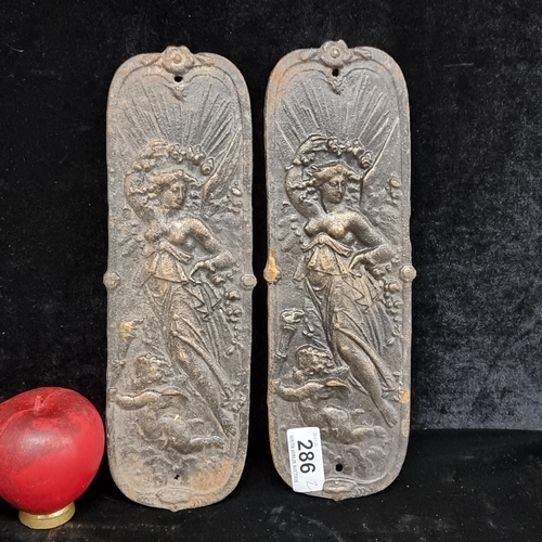 286 - A pair of cast iron door finger plates / wall plaques featuring classical female figures.