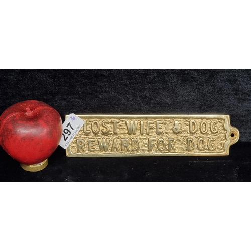 297 - A heavy brass wall plaque. Features 'Lost Wife and Dog Reward for Dog'. Bit harsh.