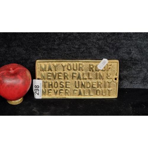 298 - A heavy brass wall plaque. Features 'May your Roof never fall in & Those under it never fall out'.