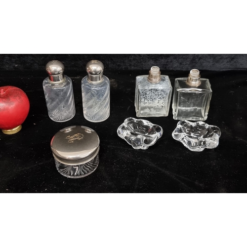 307 - A selection of cut glass vintage perfume bottles and two Daum French Crystal salt and pepper dishes.