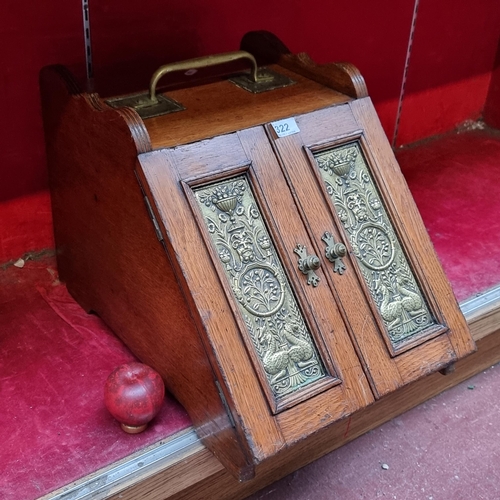 322 - A stunning Arts and Crafts brass and oak coal box. Very handsome example.