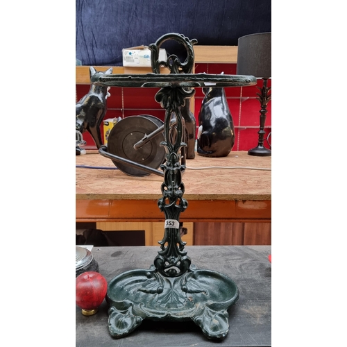 353 - A very heavy cast iron Victorian style umbrella stick stand in a green painted finish.