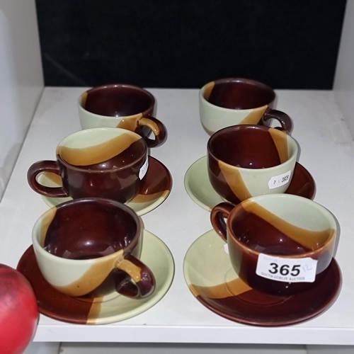 365 - Six ceramic cups and four matching saucers in earthy tones of brown, ochre and pale green.