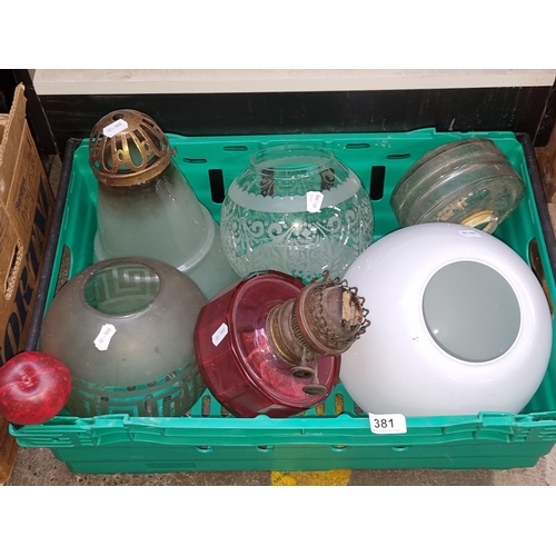 381 - Six antique and vintage glass light shades and oil lamp reservoirs including cranberry glass and etc... 