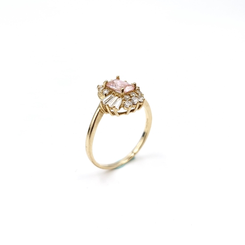 30 - An attractive Pink topaz gem set cluster ring set in nine carat gold. Ring size - N. Weight - 2.29 g... 