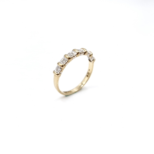 35 - Star Lot : A six diamond half eternity ring set in nine carat gold. 'DIA' stamped to band. Ring size... 