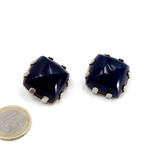 85 - A pair of designer blue polished stone clasp earrings with 'Orena' marked to clasp. Stones cold to t... 