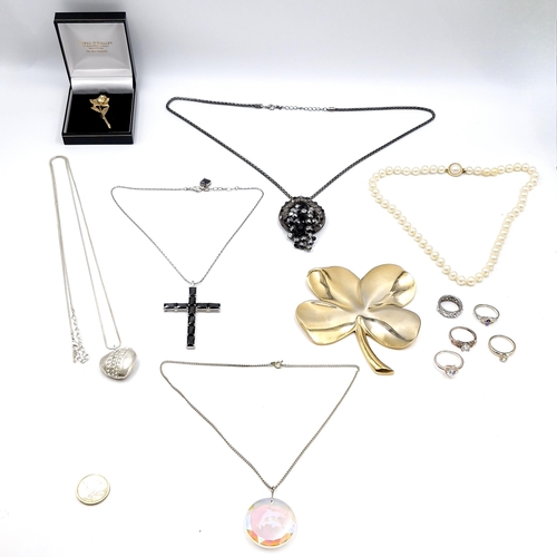 94 - A collection of assorted jewellery items consisting of a four leaf clover together with necklaces, r... 