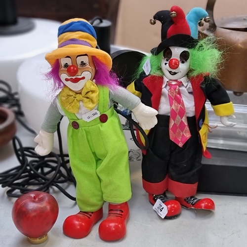 374 - Two characterful vintage clowns with hand-painted porcelain faces, one featuring a wind-up mechanism... 