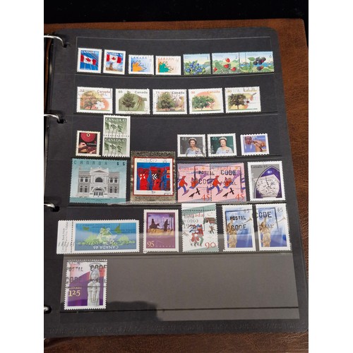 135 - A Royal Mail Universal stamp album containing stamps from Australia, Bangladesh, Canada, Mexico, Sin... 