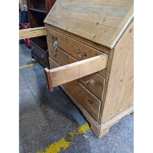 424 - Star Lot : An antique pine writing desk with three drawers, brass drop leaf handles, top section fea... 