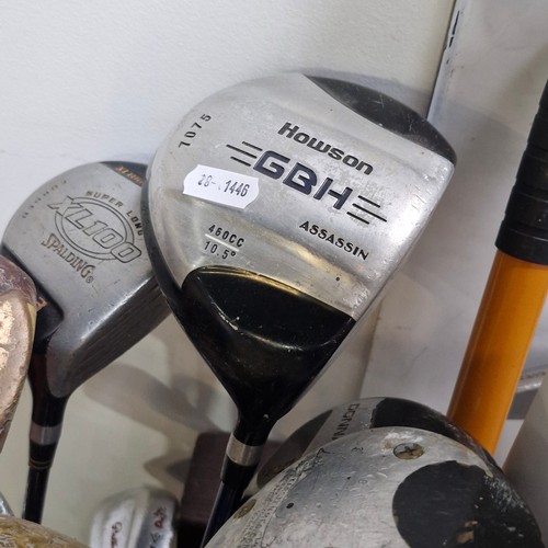 458 - A vintage mixed lot of golf clubs comprising of a driver, woods, irons and wedges from various diffe... 