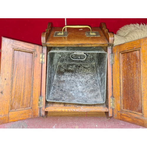 322 - A stunning Arts and Crafts brass and oak coal box. Very handsome example.