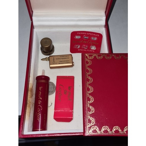 380 - A designer Red Cartier box for les Must de Cartier lighter. Includes gas re-filler and replacement f... 