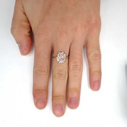 30 - An attractive Pink topaz gem set cluster ring set in nine carat gold. Ring size - N. Weight - 2.29 g... 